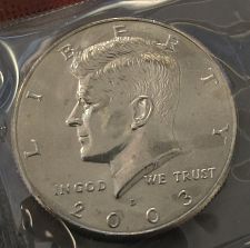 2003 Kennedy half dollar die crack error showing raised metal line through obverse field